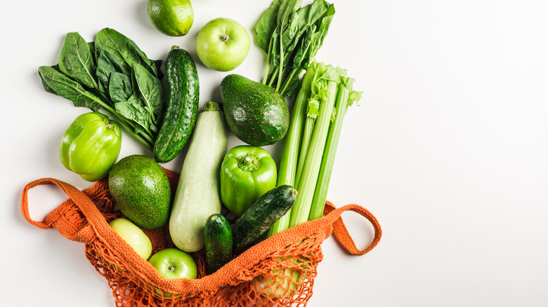 Orange bag spilling green produce