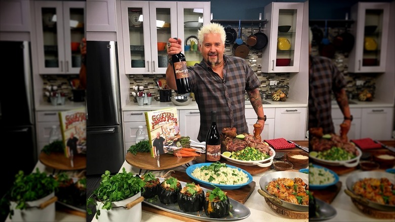 Guy Fieri holding a bottle of wine