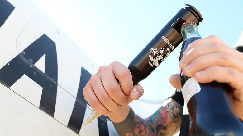 Man using Bottle Breacher to open a bottle