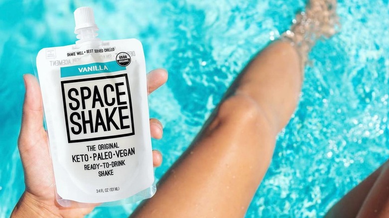 Woman holding Space Shake poolside