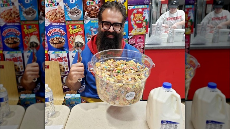 man with spoon giant bowl of cereal milk competiting in cereal killerz challenge