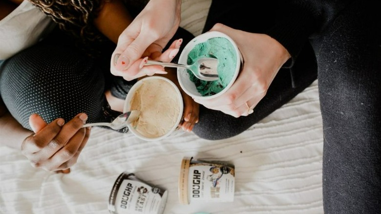 two friends eating doughp cookie dough