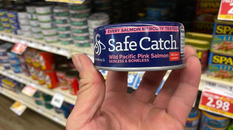 Shopper holding can of Safe Catch salmon