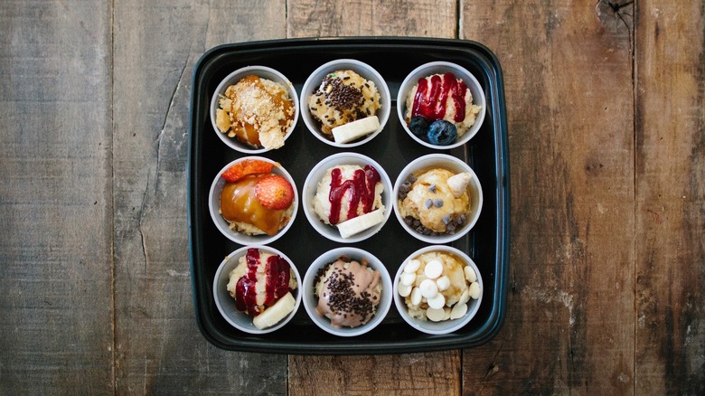 Sample cups with various bread pudding flavors in square tray