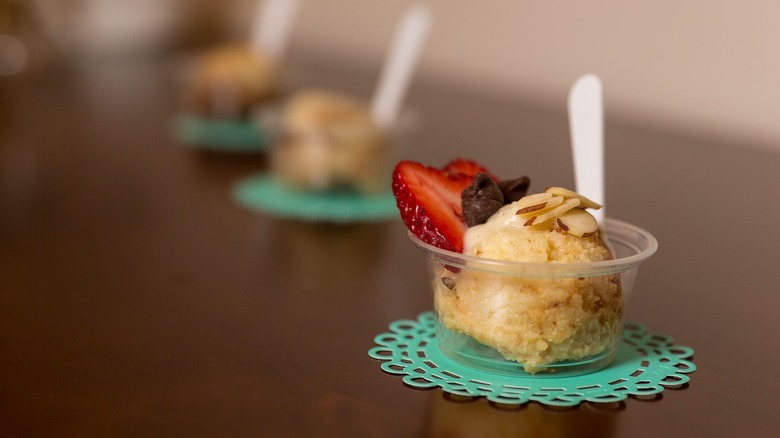 Sample cup of bread pudding with strawberries, chocolate chips, and almonds