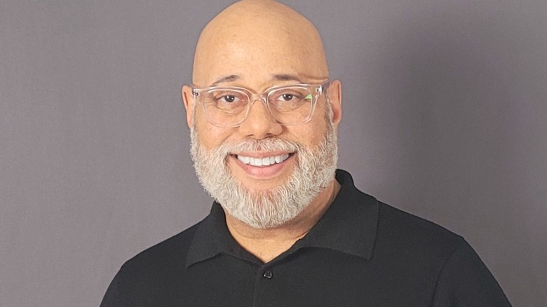 Actor Scott Martin Brooks smiling against gray background