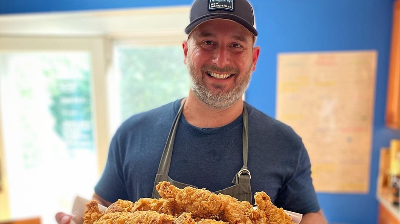 Bryan Roof holding plate of fried chicken