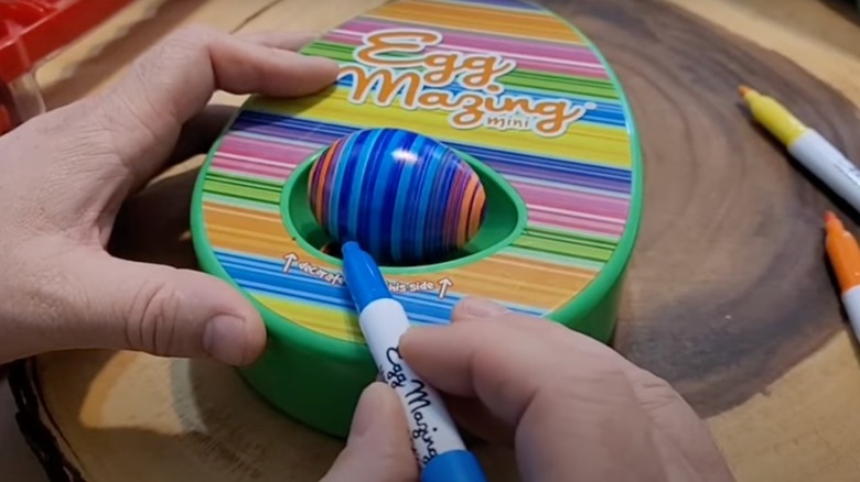 someone demonstrating the using the Eggmazing 