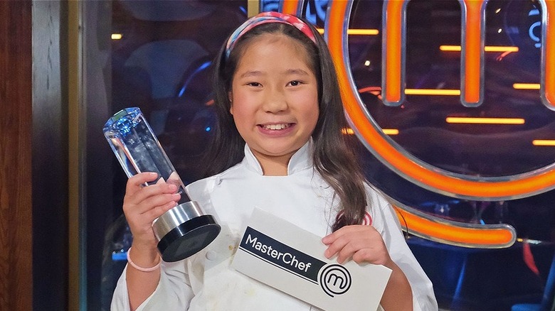 Smiling Liya Chu holding MasterChef Junior awards