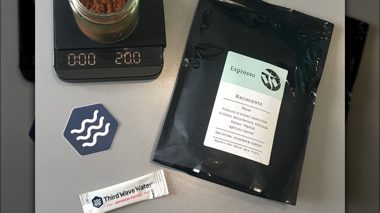 Third Wave Water packet and logo next to weighed coffee