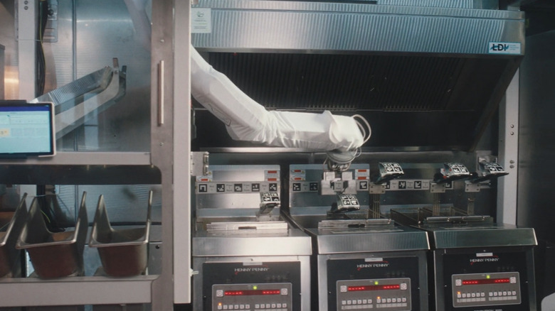 Robotic arm flipping fries and burgers