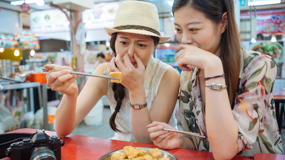 Women eating stinky tofu