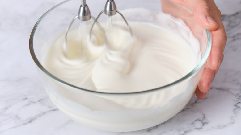 Egg whites being whisked in a bowl