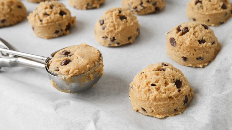 portions of chocolate chip cookie dough on a baking sheet