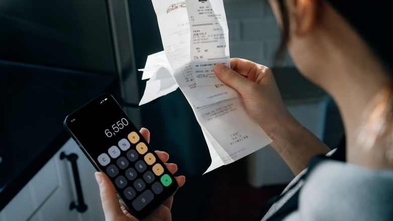 woman with receipts and calculator