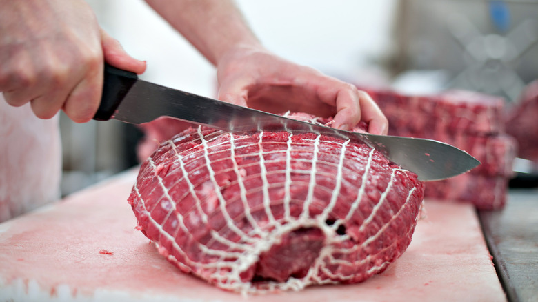 chef slicing chuck meat