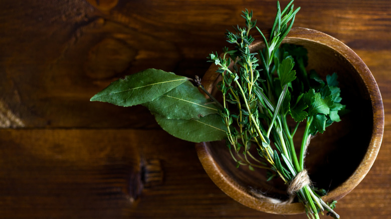 Bouquet garni in a wooden bowl