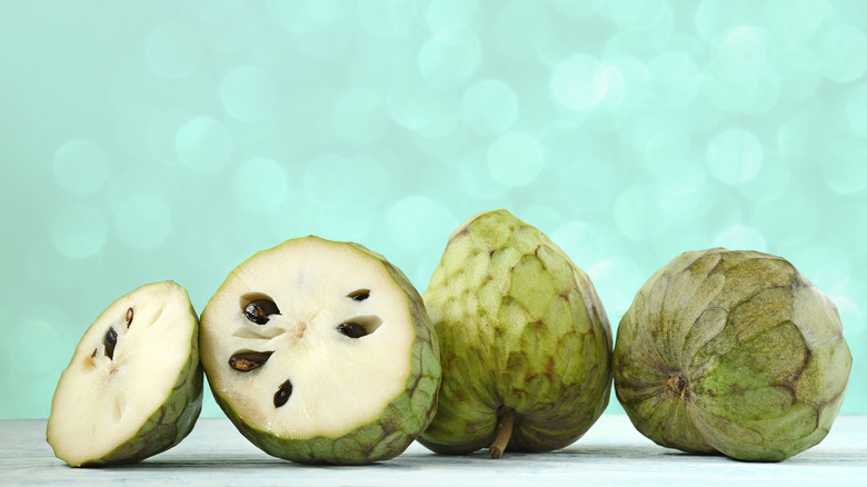 Cherimoyas against a green background