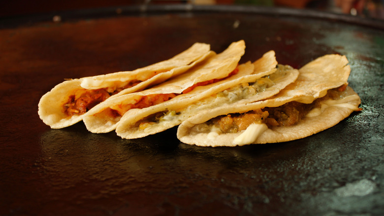 Quesadillas cooking on a comal