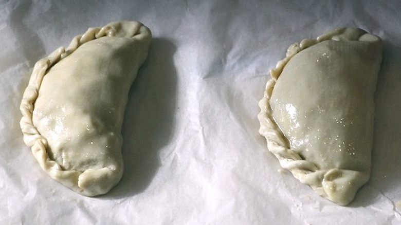 Two unbaked Cornish pasties