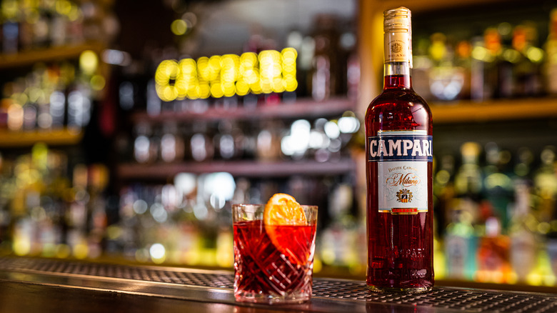 Campari and negroni next to each other on a bar