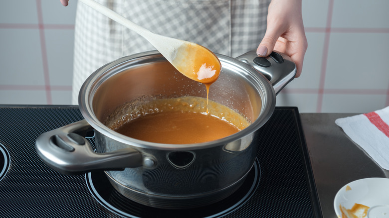 person cooking sugar and milk