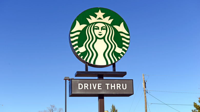 Starbucks drive-thru sign against a clear blue sky