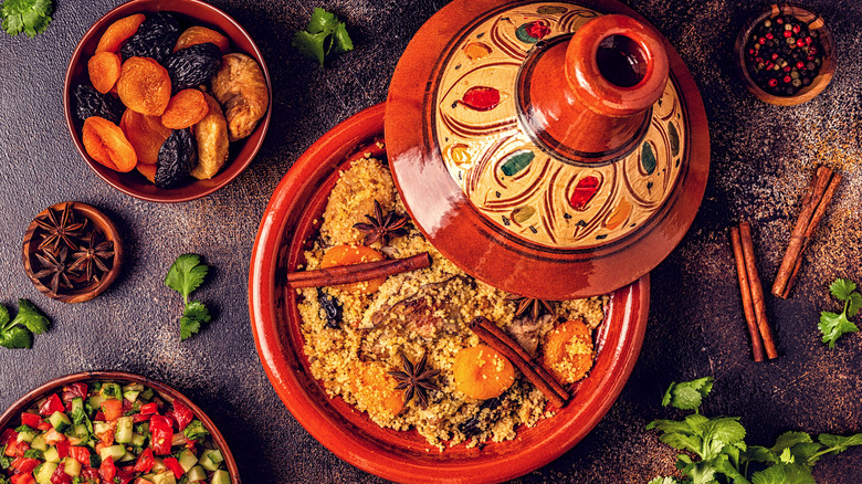 Top view of red tagine dish surrounded by spices