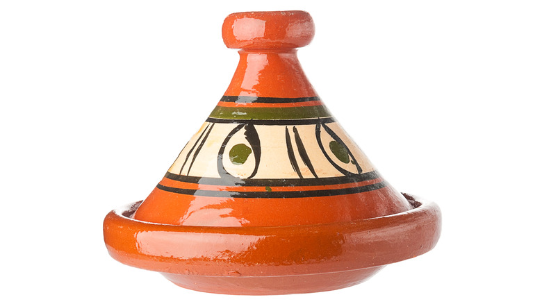 Colorful orange tagine pot with painted details