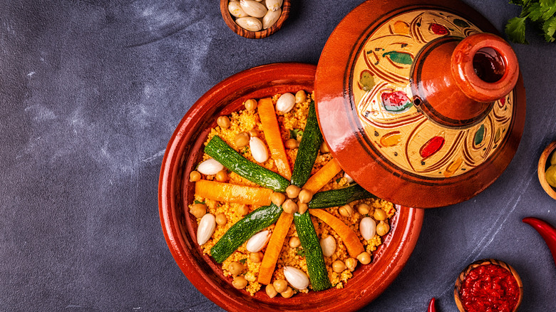 Red tagine dish pot with lid open and food inside