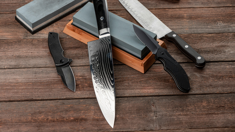 Whetstone blocks and knives on wood table