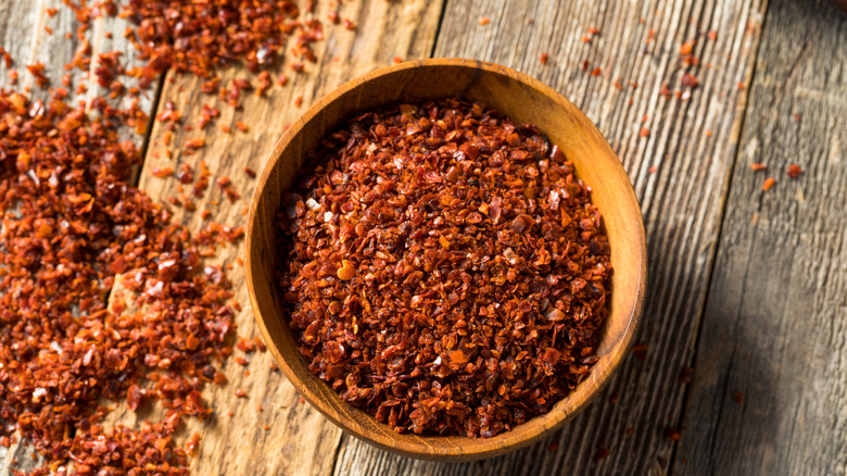 Aleppo pepper flakes in wooden bowl