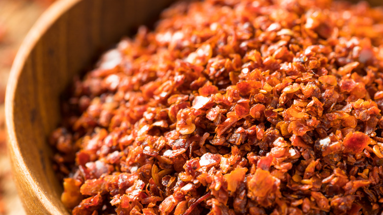 Aleppo pepper flakes in wooden bowl