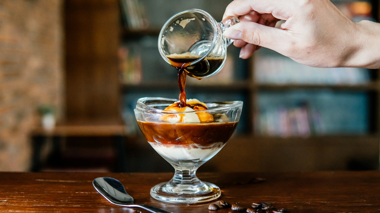 Shot of espresso poured onto ice cream in glass dish