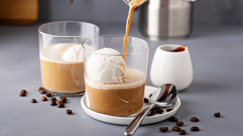 Two affogatos in glasses next to coffee beans and spoon