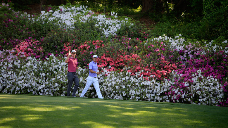 Two golfers walking near the 13th hole of the Masters Tournament