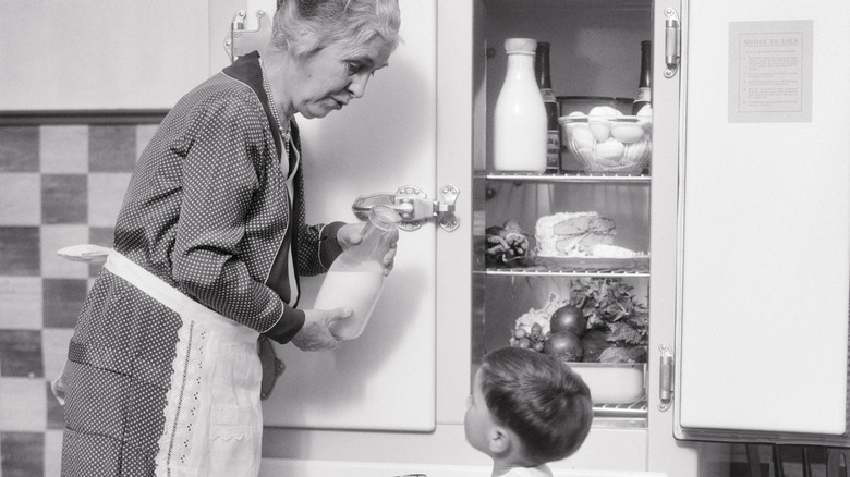 Grandmother and grandson by old refrigerator