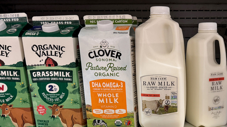 Organic and raw milk in grocery store fridge