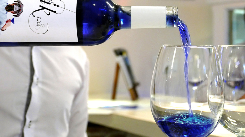 pouring a glass of blue wine