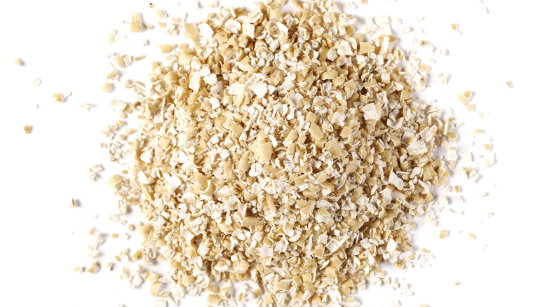 Oat bran pile isolated on white background, top view