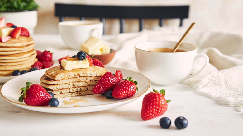 pancakes topped with butter and fruit