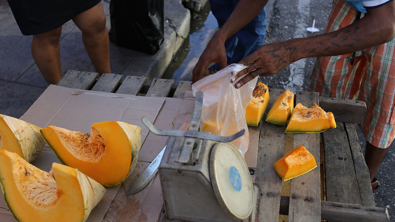 vendor selling slices of calabaza squash