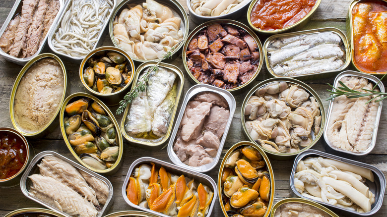 Assortment of cans of canned with different types of fish and seafood,