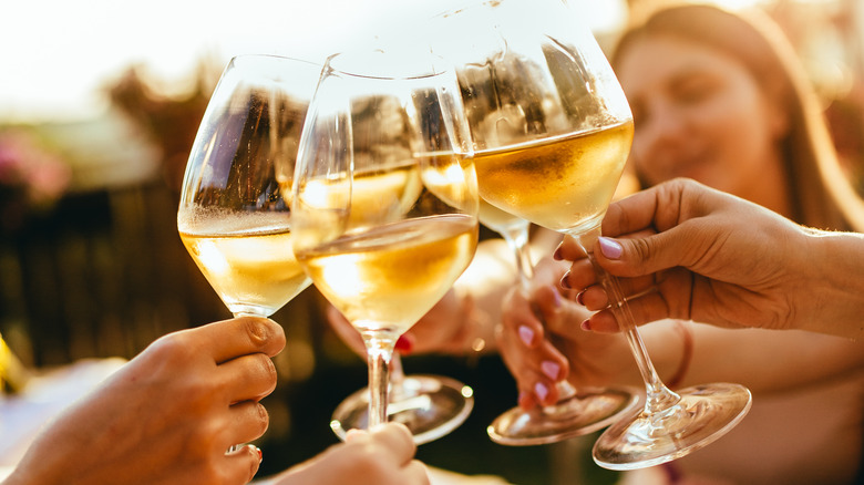 Glasses clinking on sunny patio