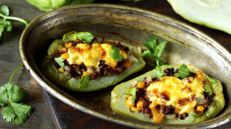 Baked chayote squash stuffed with meat, corn, and cheese