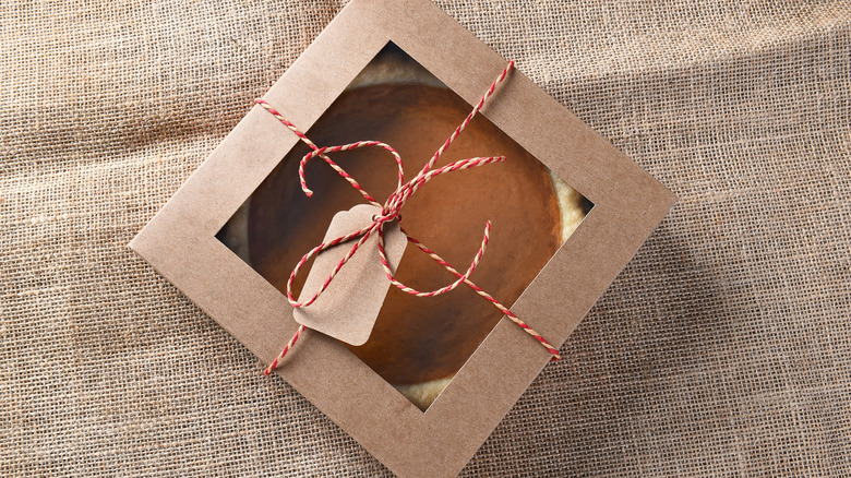 A whole pie in a bakery box