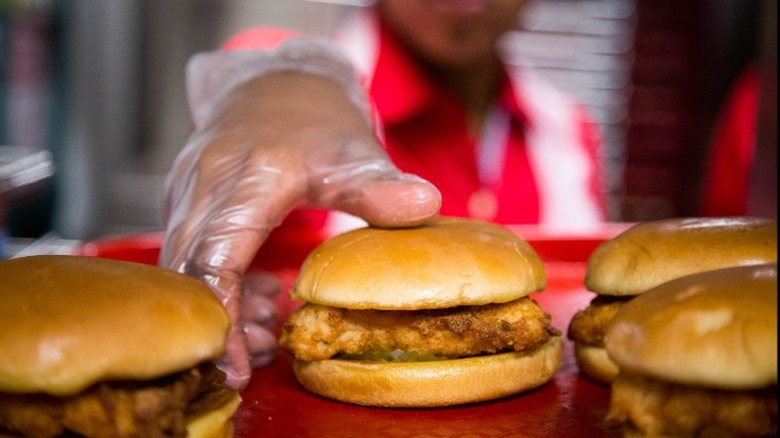 Chick-Fil-A employee picking up sandwich