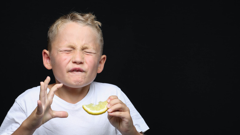 Boy in pain after eating lemon