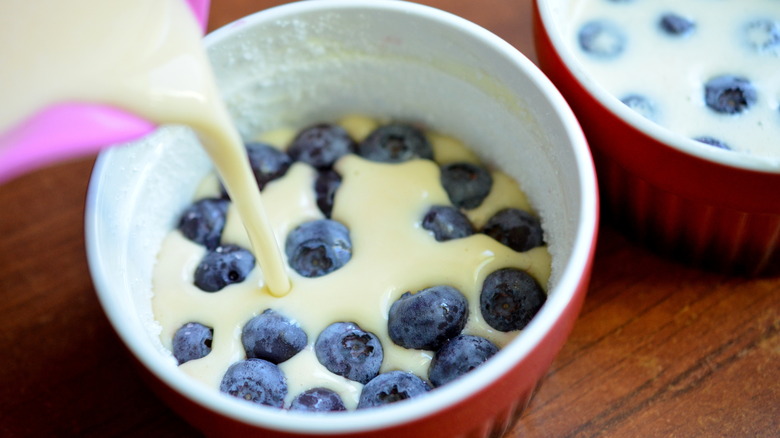 pouring batter onto fruit