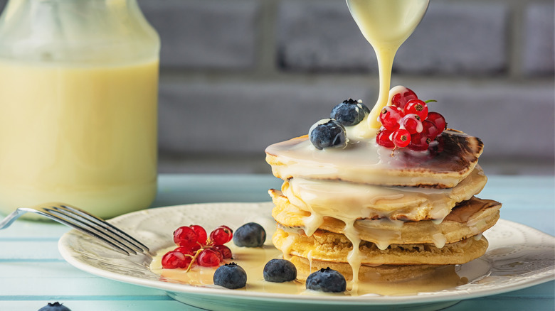 Stack of pancakes with condensed milk